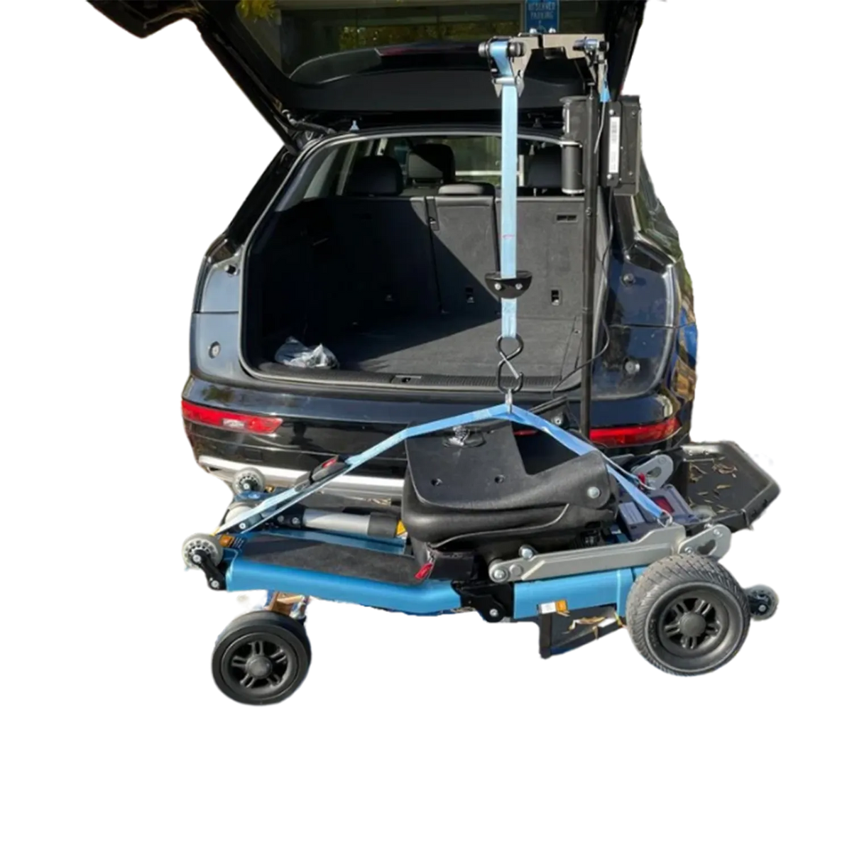 A blue and black electric wheelchair mounted on a lift platform, shown with its trunk open in a vehicle to demonstrate the transfer system. The background has been digitally removed to solid white.