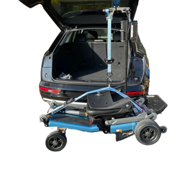 A blue and black electric wheelchair mounted on a lift platform, shown with its trunk open in a vehicle to demonstrate the transfer system. The background has been digitally removed to solid white.