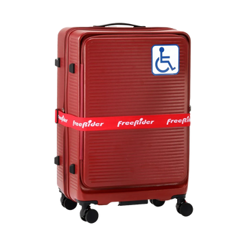 A red hard-shell spinner suitcase with a blue and white wheelchair accessibility symbol sticker on the front, wrapped in a red FreeRider brand strap, shown on a plain white background.